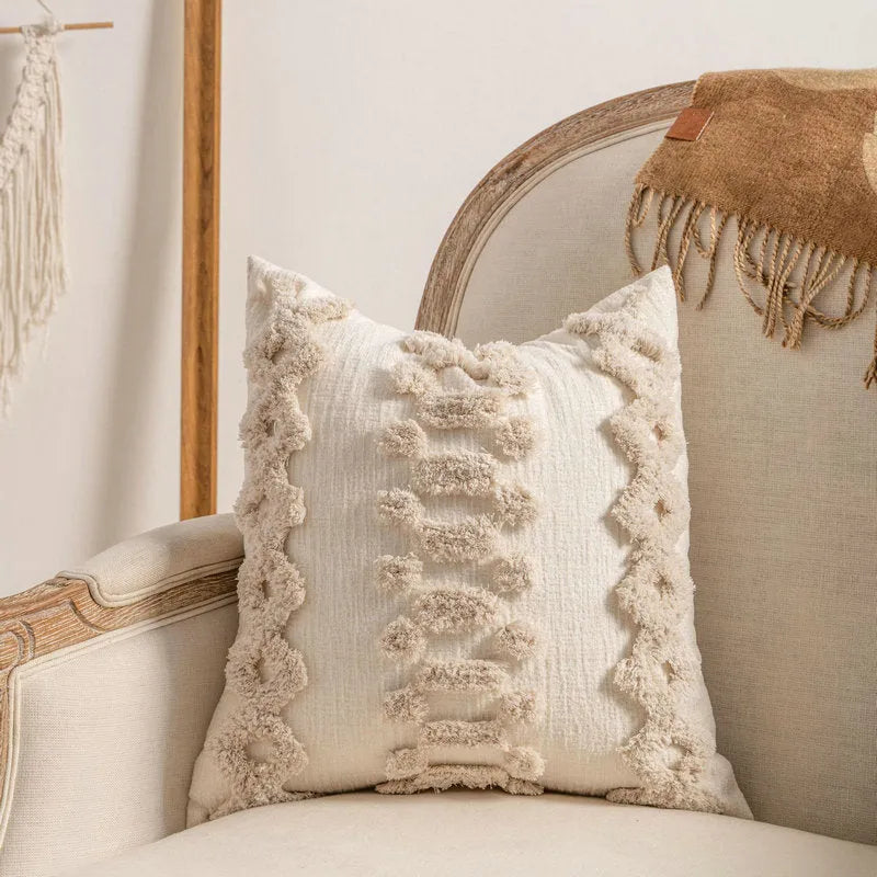 Knitted cushion cover with tassel trim in a printed spiral dots pattern, shown in 45x45cm size.