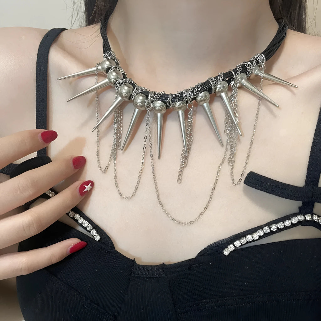 Leather necklace with winding round beads, tassel detail, and electroplated point rivets in casual style.