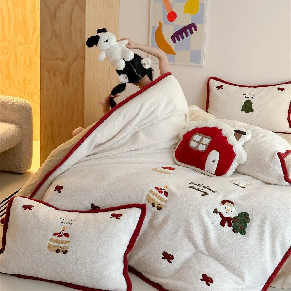 Girl's cartoon winter Christmas themed bedding four-piece set with duvet cover, sheet and pillowcases on a bed.