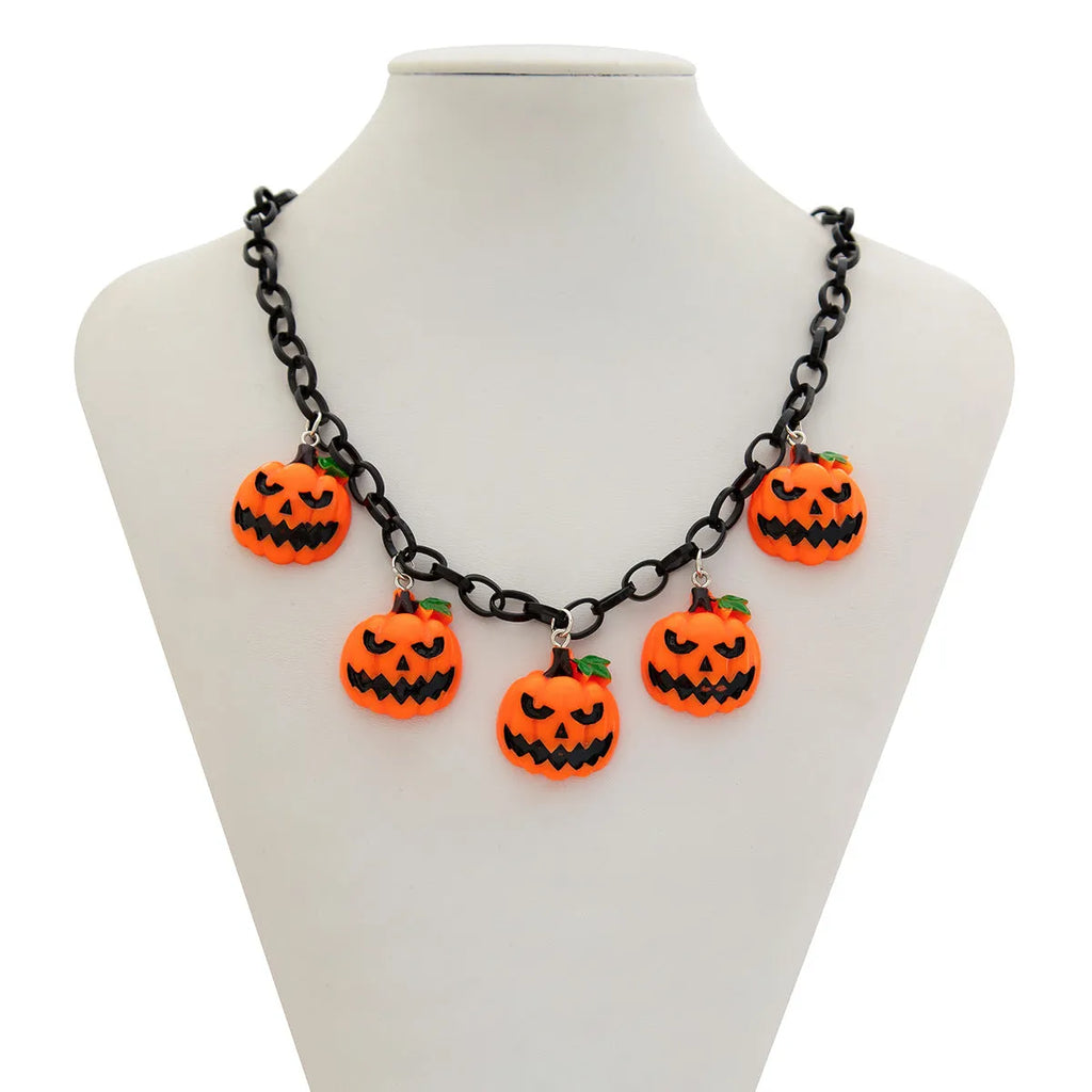 Halloween necklace showing a cartoon ghost and pumpkin acrylic pendant on a metal chain, in mixed colours.