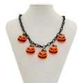 Halloween necklace showing a cartoon ghost and pumpkin acrylic pendant on a metal chain, in mixed colours.