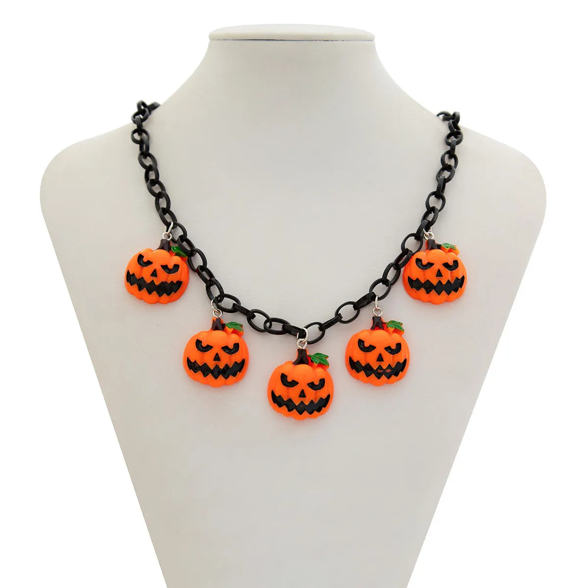 Halloween necklace showing a cartoon ghost and pumpkin acrylic pendant on a metal chain, in mixed colours.