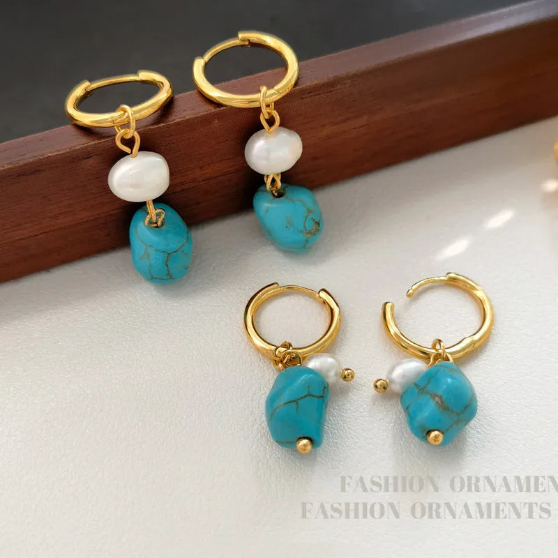 A pair of geometric turquoise and cultured pearl clip-on earrings on a copper setting.