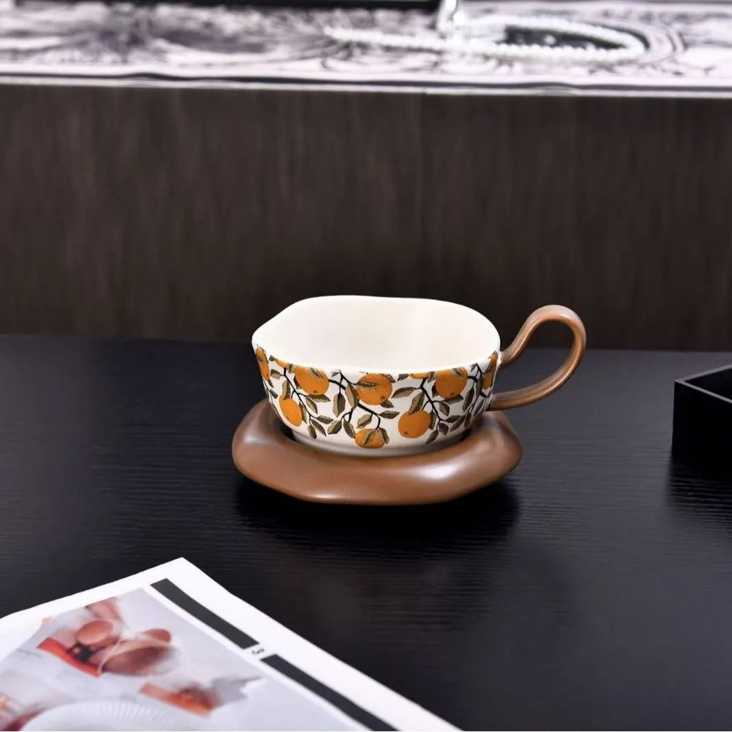 Antique style ceramic coffee cup and saucer set with medieval decoration in black or orange