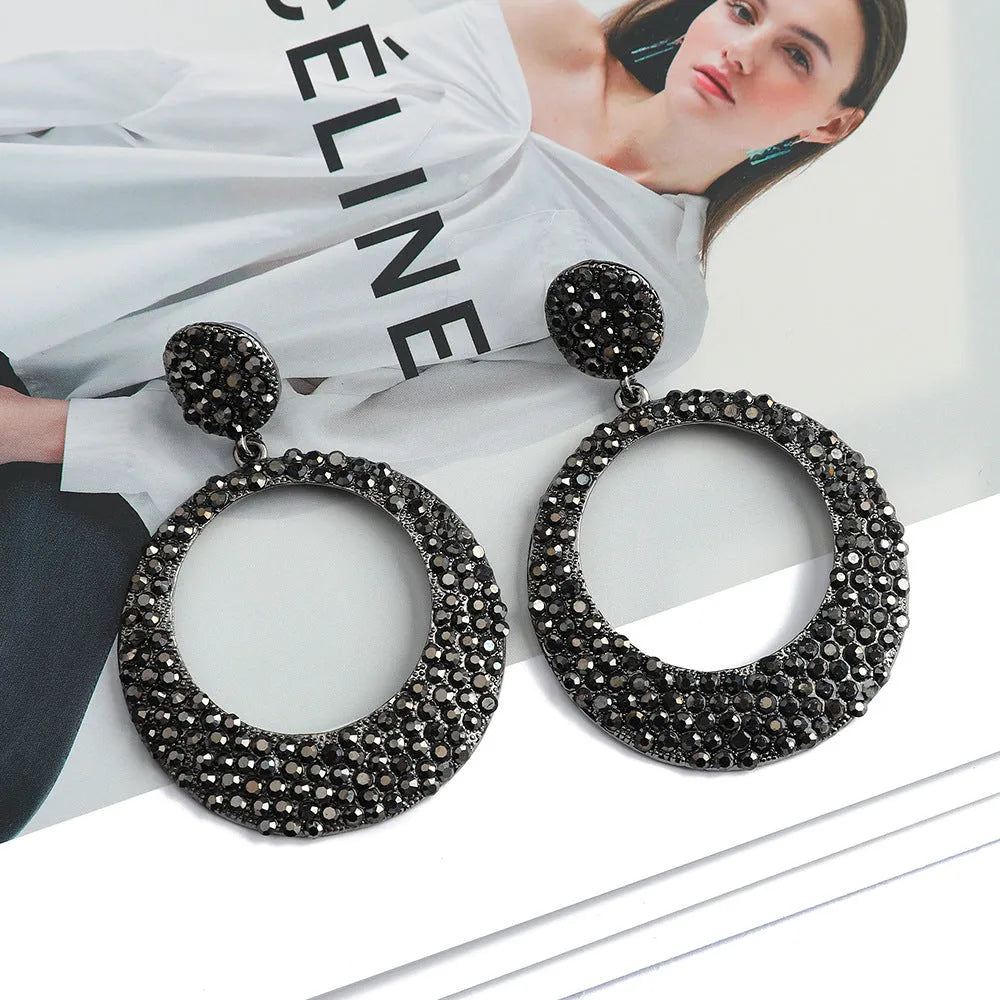 Cartoon style metal earrings with colourful diamond decorations on large round pendants