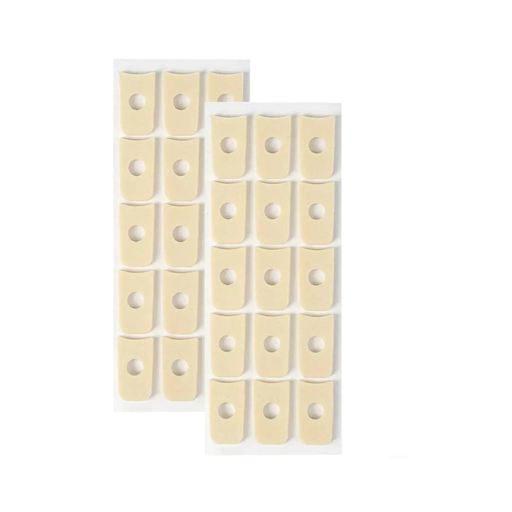 Assortment of clear gel corn protector pads in oval, U-shaped, and circular shapes on a white background.