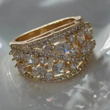 Women's round hollow copper ring with gemstone accents in gold or platinum plating with white or blue stones