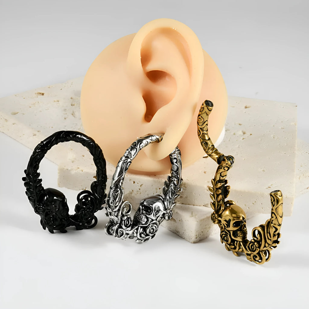 A pair of stainless steel fashion earrings featuring a geometric totem pattern with an electroplated coloured finish.