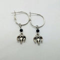 Silver coloured round ring earrings with Tibetan antelope design inspiration