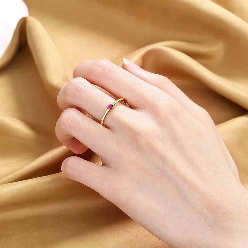 Copper ring with a fine circle geometric shape and single diamond detail, shown in a choice of colours.