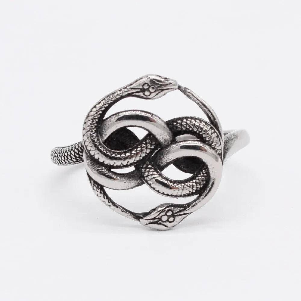 Close-up of a titanium steel double snake ring in a retro style on a grey background.