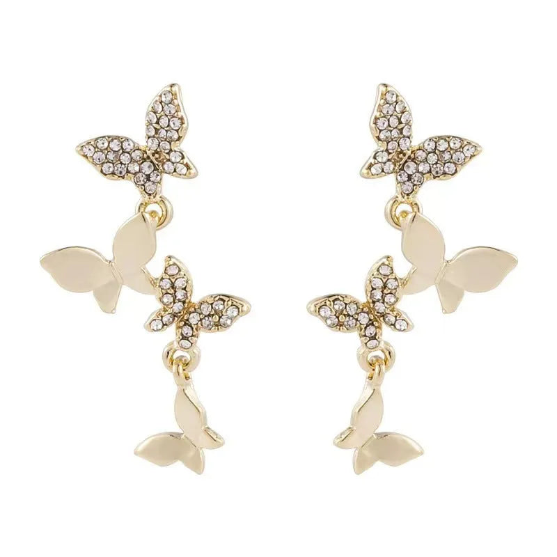 Women's copper butterfly drop earrings with gold finish showing four butterfly design