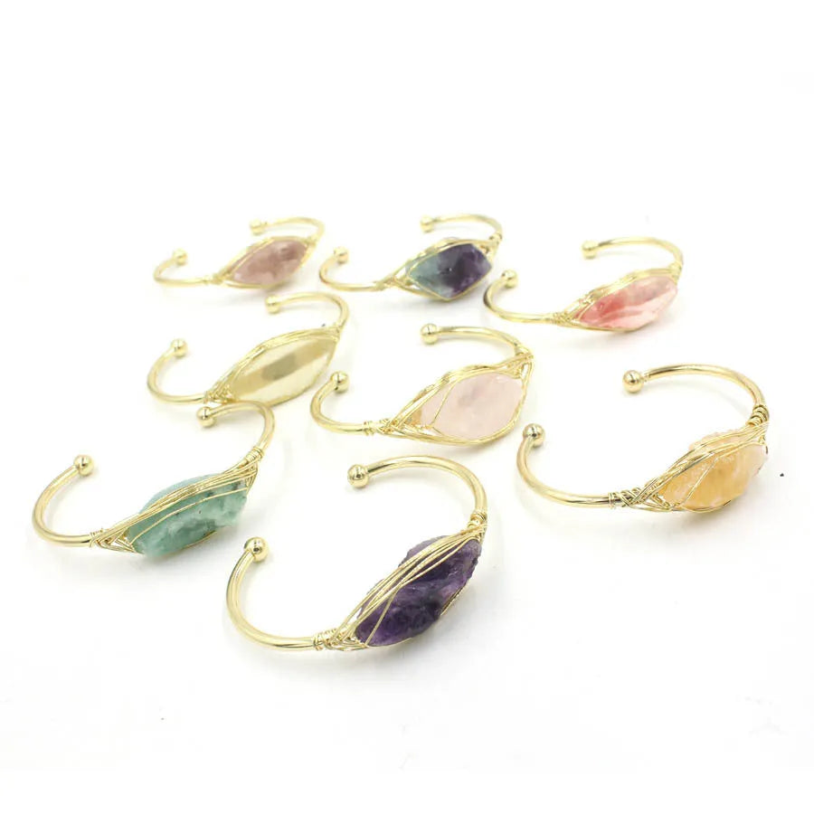 Natural raw gemstone winding bracelet with amethyst, pink crystal, and green fluorite stones on a string with a clasp.