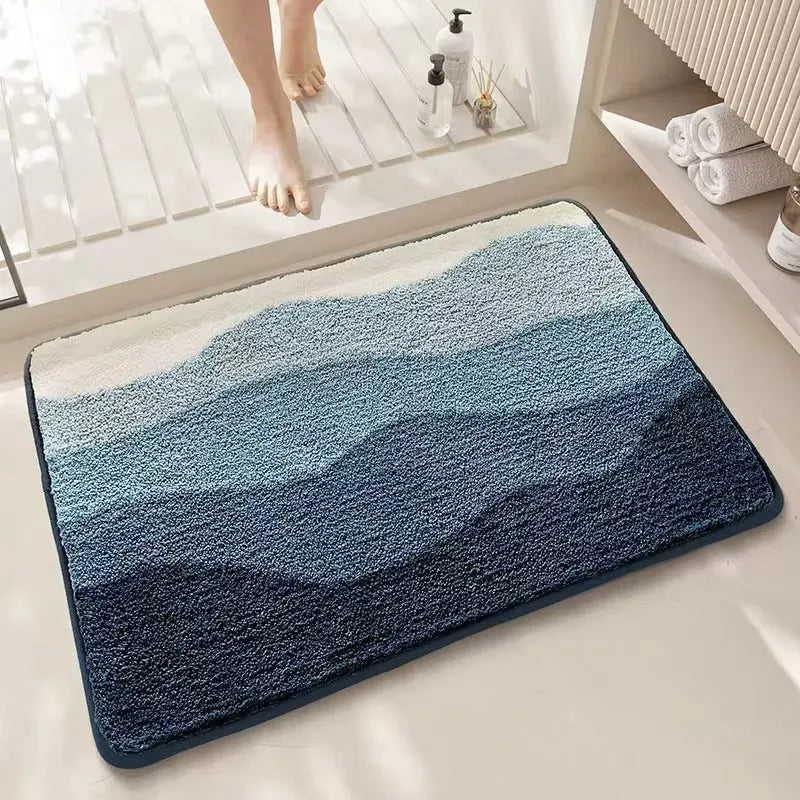 Square rainbow print carpet mat in Sky Sea colour with a plastic anti-slip bottom, shown in two sizes.
