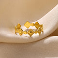 Gold coloured titanium steel women's ring with geometric shape and large diamond stone.