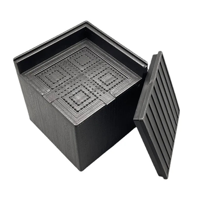Set of four black thickened plastic bed foot mats for furniture height adjustment.