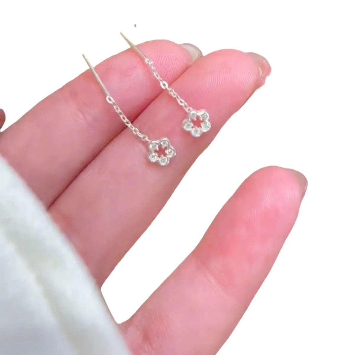 Silver flower stud earrings with hollow petal designs on alloy posts for women