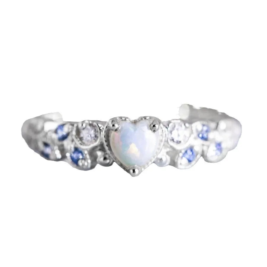 White electroplated alloy women's ring with a heart shape, featuring peach opal and ocean heart design details.