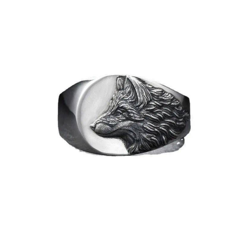 Silver geometric wolf head men's ring on a dark background, showing angular design details.