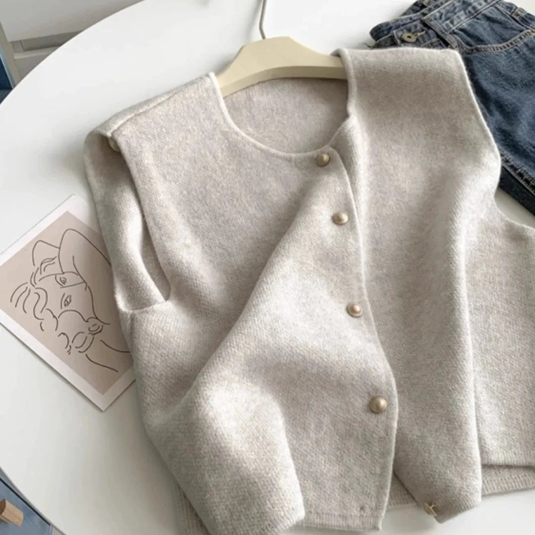 Women's thin polyester pullover vest with half sleeves in a choice of six colours on a hanger.