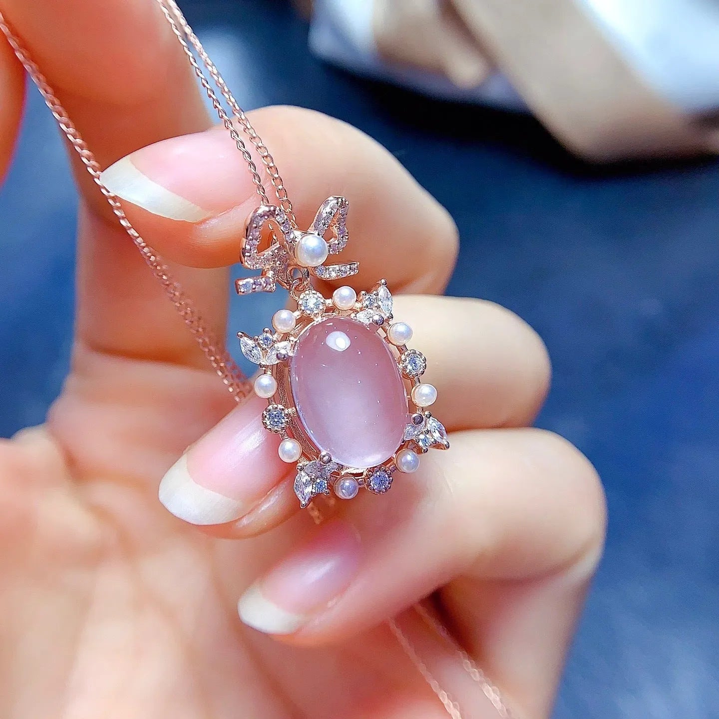 Pink rose quartz geometric pendant on a silver and rose gold plated necklace chain.