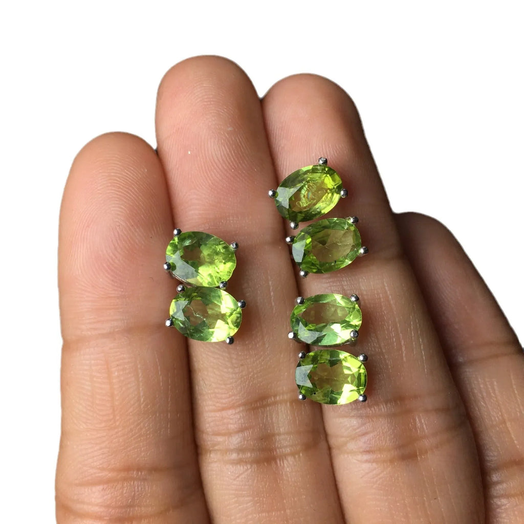 Natural grass green olivine faceted stud earrings in S925 sterling silver on a white background.