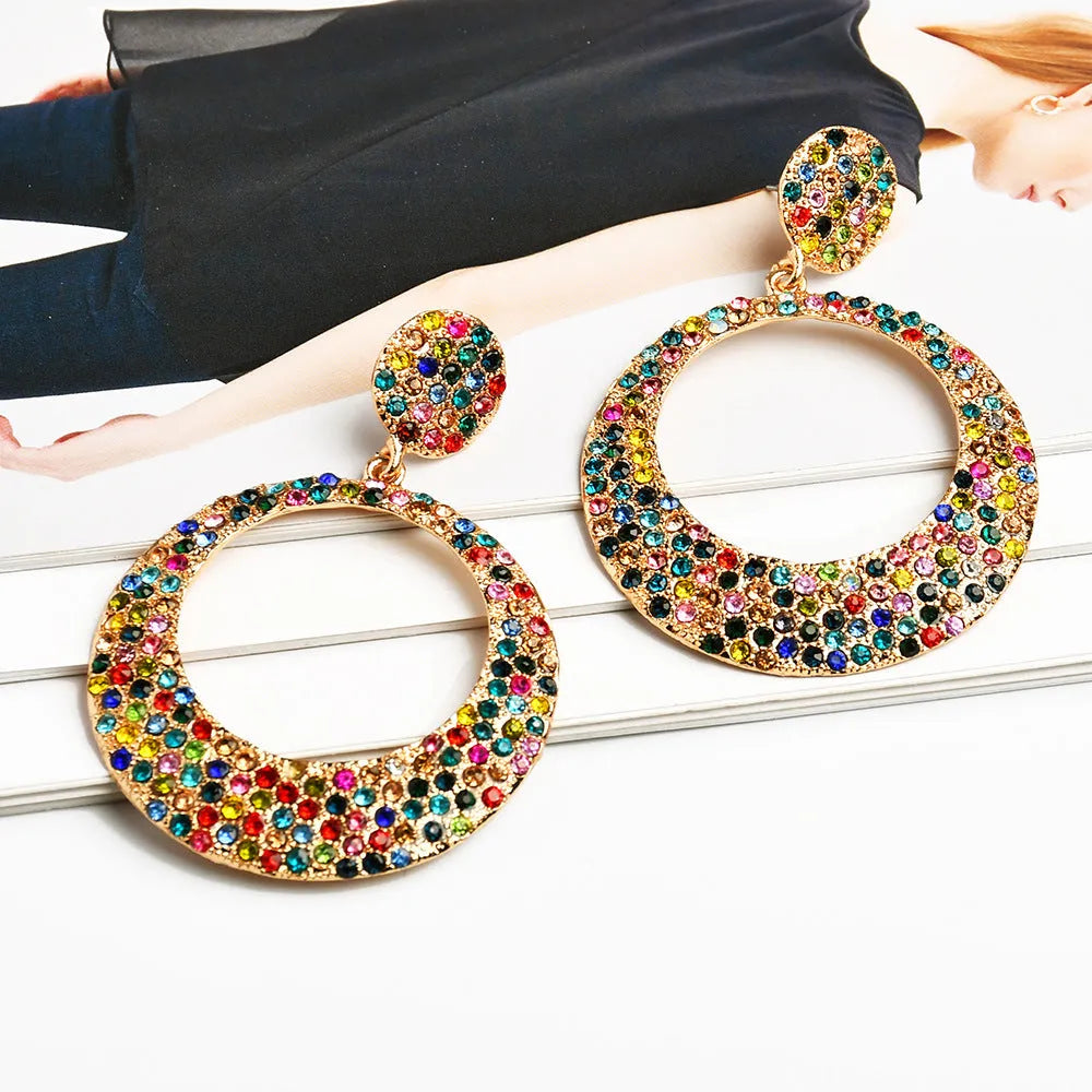 Cartoon style metal earrings with colourful diamond decorations on large round pendants