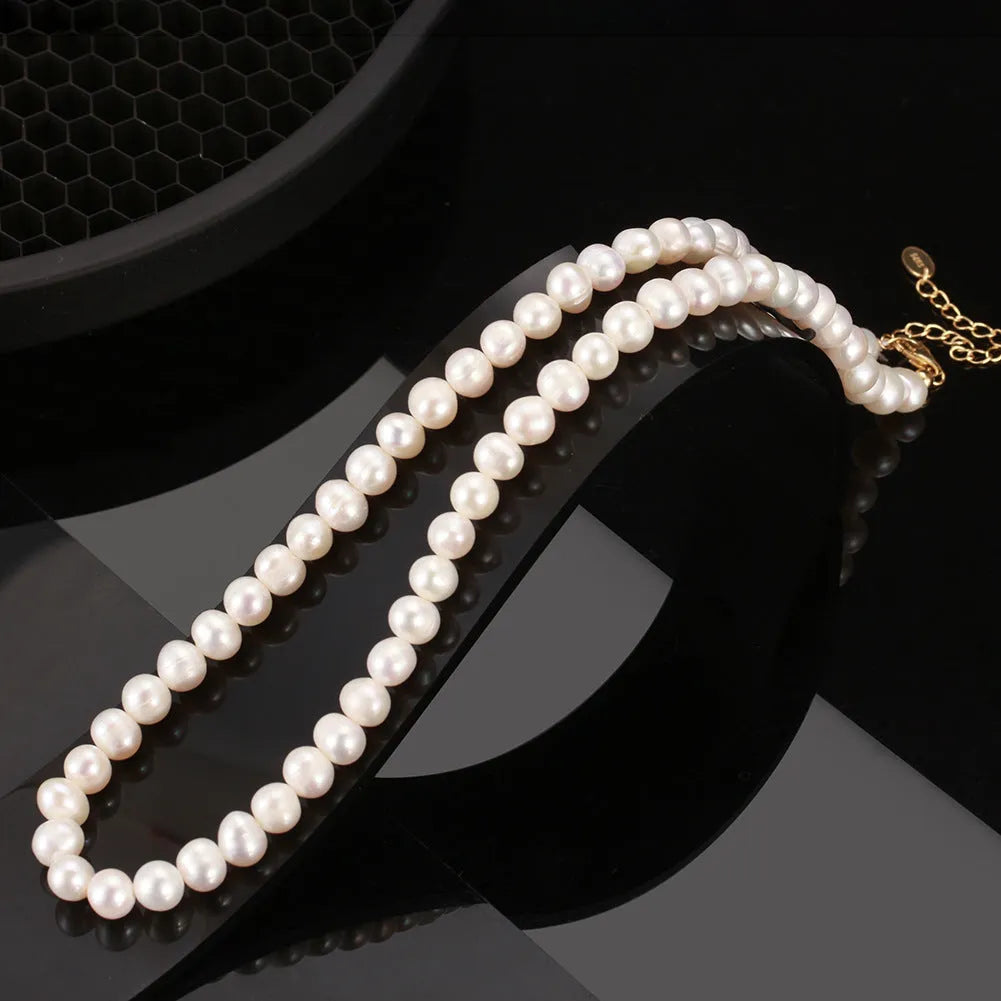 Women's adjustable silver necklace featuring a single round 6-7mm freshwater pearl on a chain.