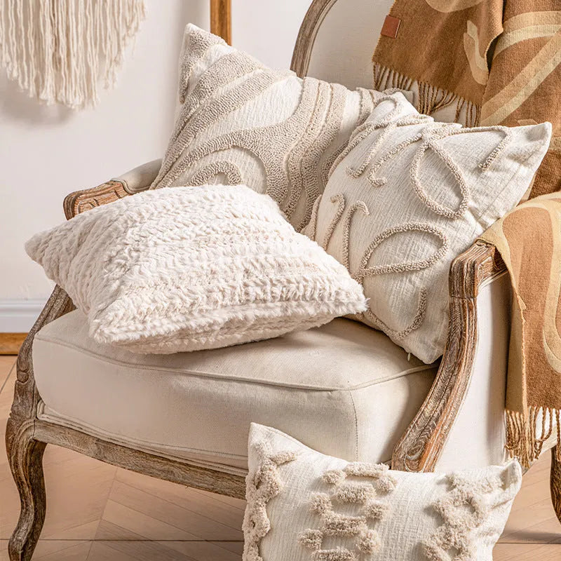Knitted cushion cover with tassel trim in a printed spiral dots pattern, shown in 45x45cm size.