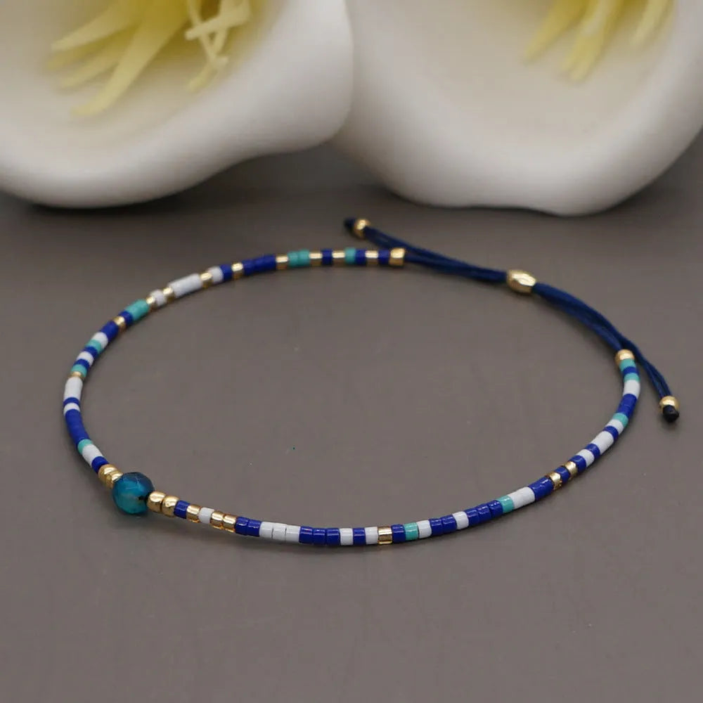 Handmade bohemian style bracelet with colourful geometric glass and coloured glaze beads.