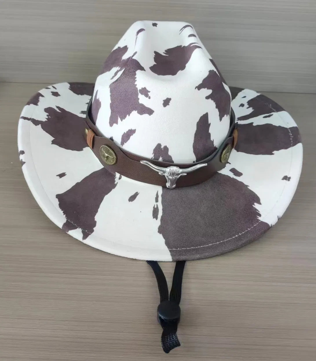 Brown leather velvet Western cowboy hat with a curved edge brim and conical crown.