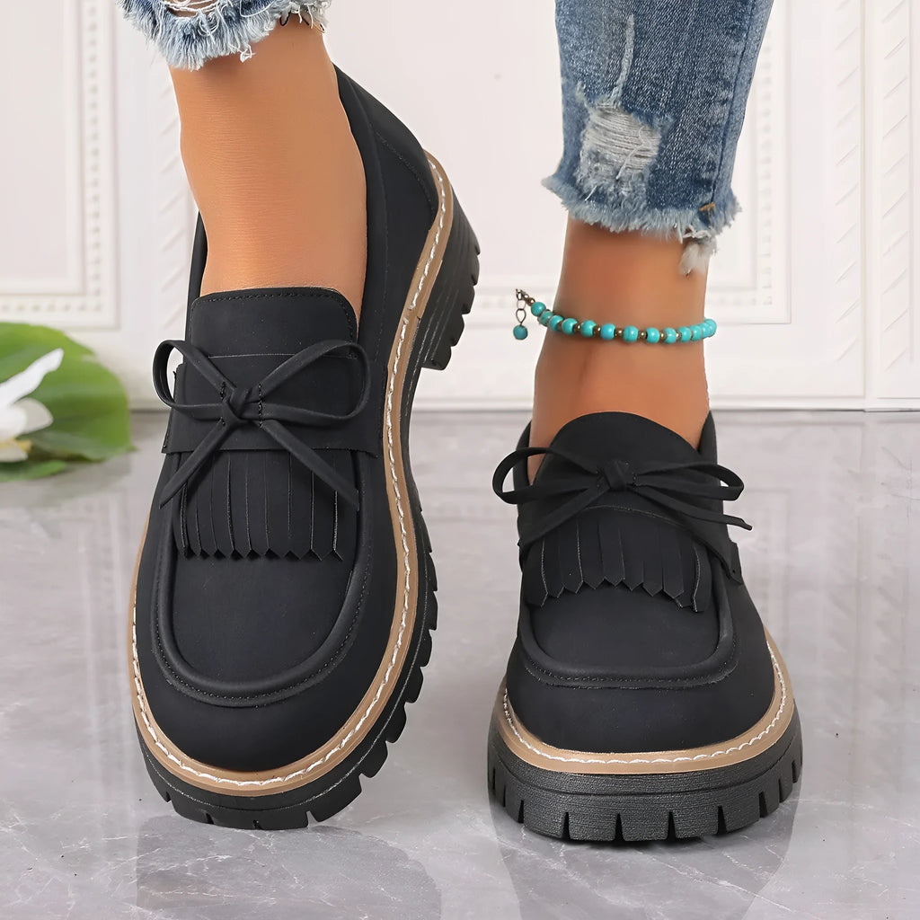 Plus size women's black loafers with tassel decoration and bowknot detail on round toe