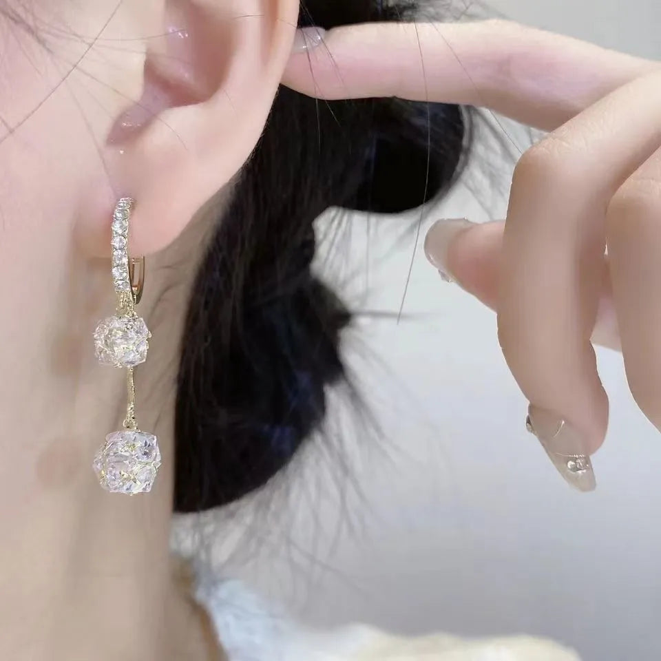 Silver coloured women's earrings with tassel ball and rhinestone ball pendants on ear clips