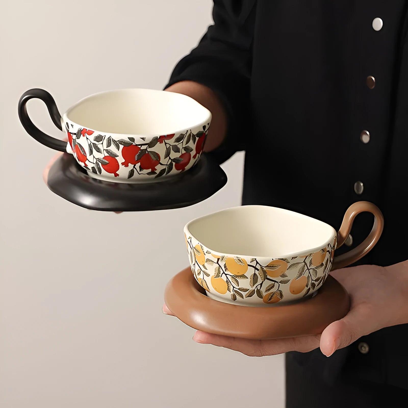 Antique style ceramic coffee cup and saucer set with medieval decoration in black or orange