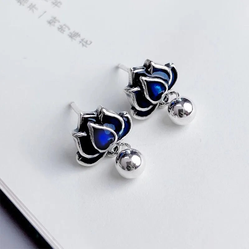 Blue lotus seedpod earrings with artistic tassel detailing on flower-shaped 1.2cm studs