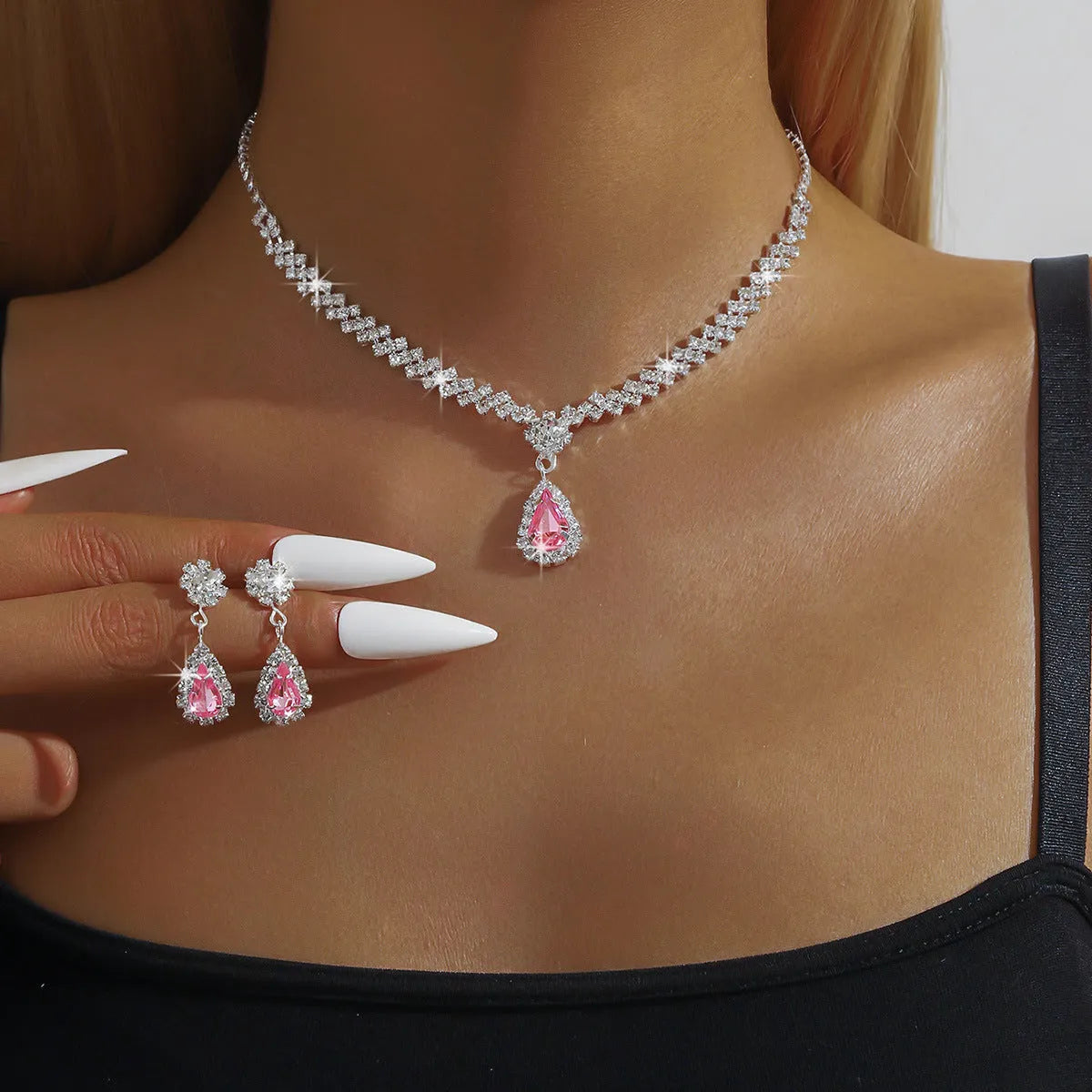 Claw chain necklace and matching drop earrings set with rhinestones in multiple colours.