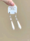 Silver geometric heart-shaped clip-on earrings with rhinestones and a dangling star tassel charm.