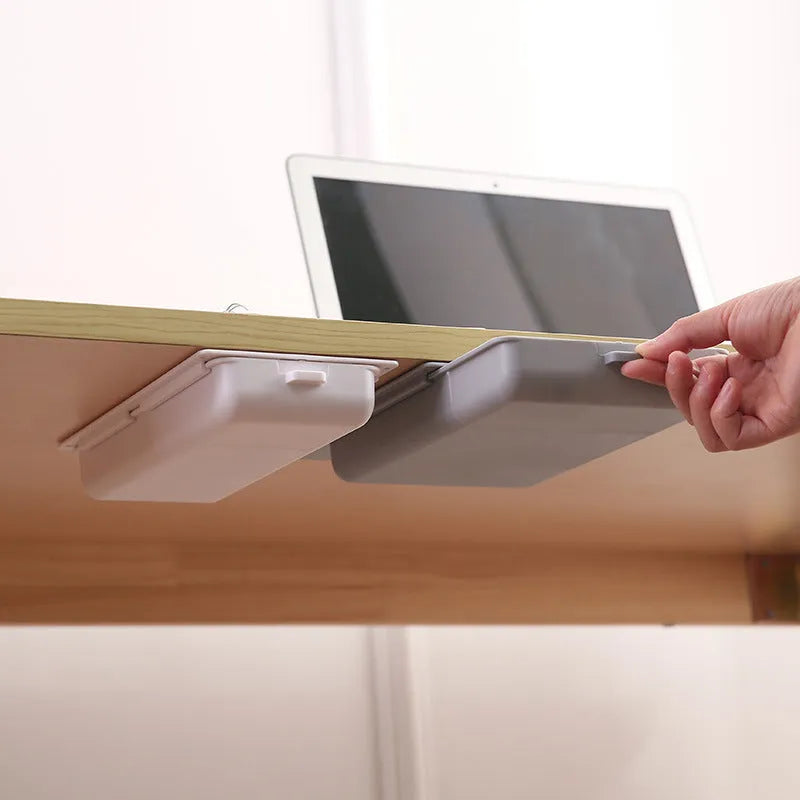 White adhesive under desk storage drawer with lid open, showing interior grid divider.