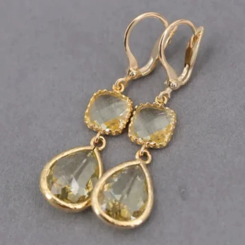 Gold geometric long fringe drop earrings with water droplet crystal decorations on copper material