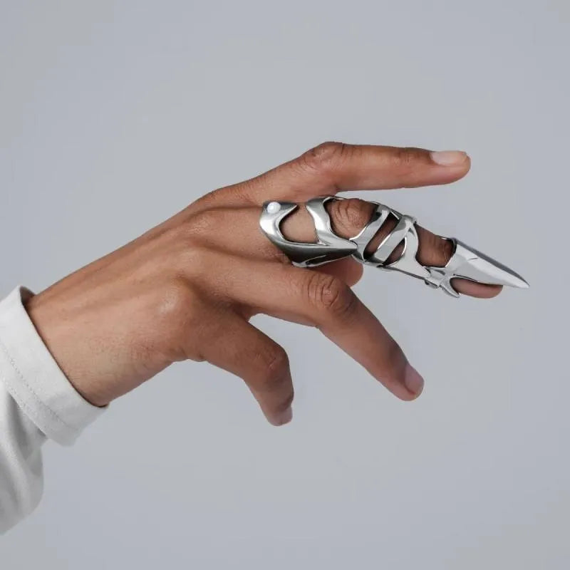Silver alloy finger stall ring for punk and medieval armour costumes on a finger.