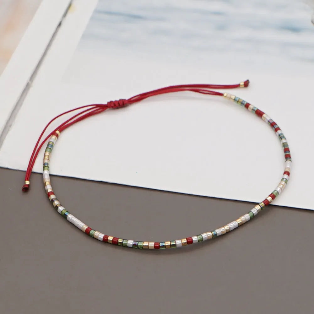 Handmade bohemian style bracelet with colourful geometric glass and coloured glaze beads.