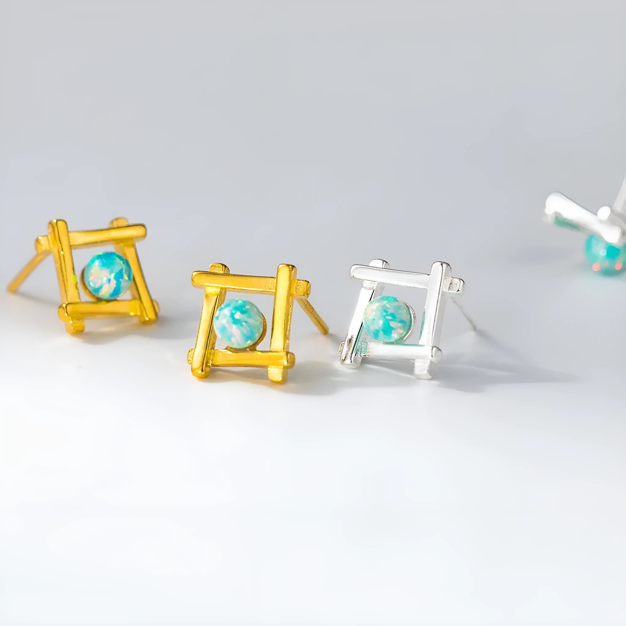 Geometric cross-shaped silver stud earrings for women on a white background.