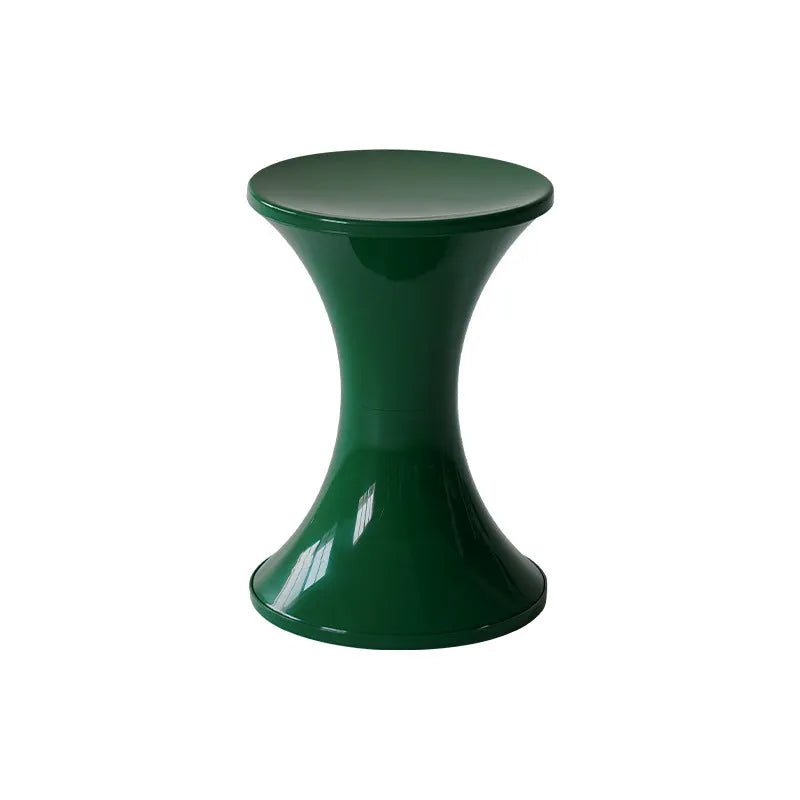 Hourglass-shaped plastic stool in green for changing shoes, used by an adult and child.