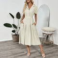 Light green women's shirt dress with lapel collar, waist tie, and side pockets on a model.