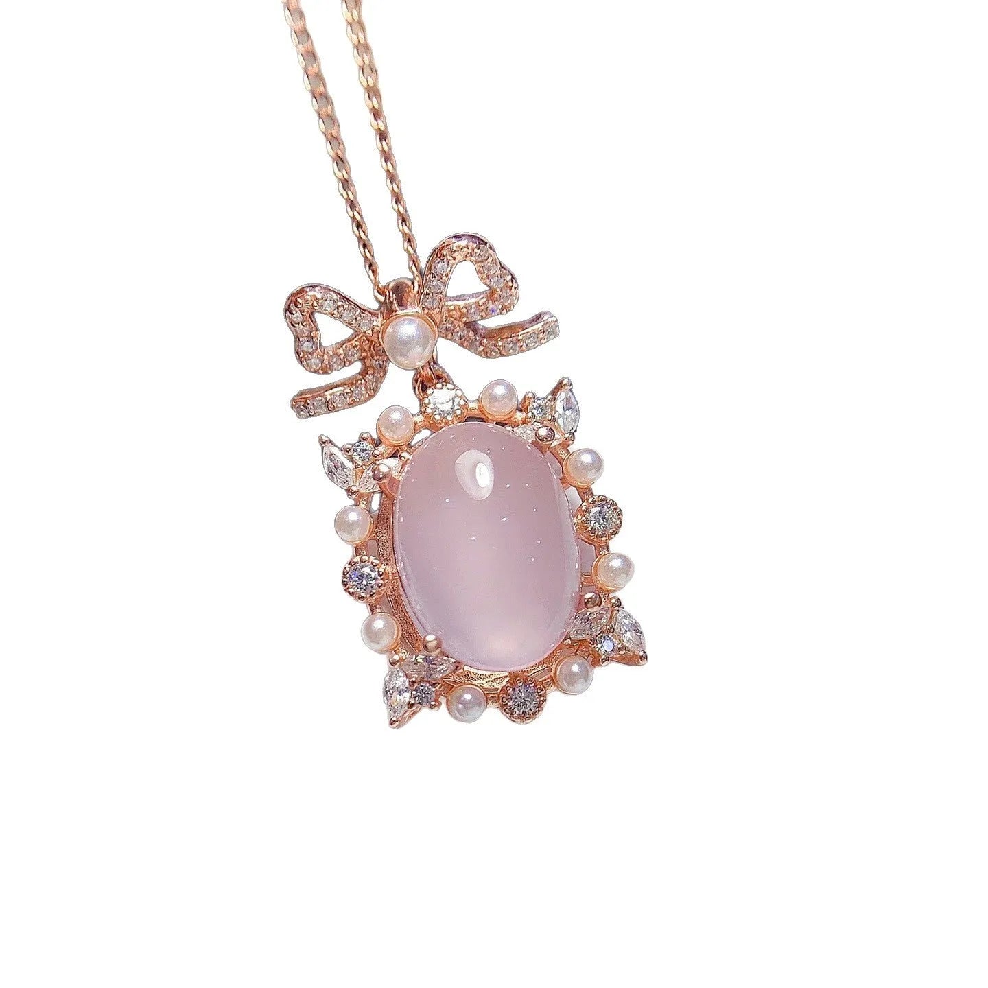 Pink rose quartz geometric pendant on a silver and rose gold plated necklace chain.
