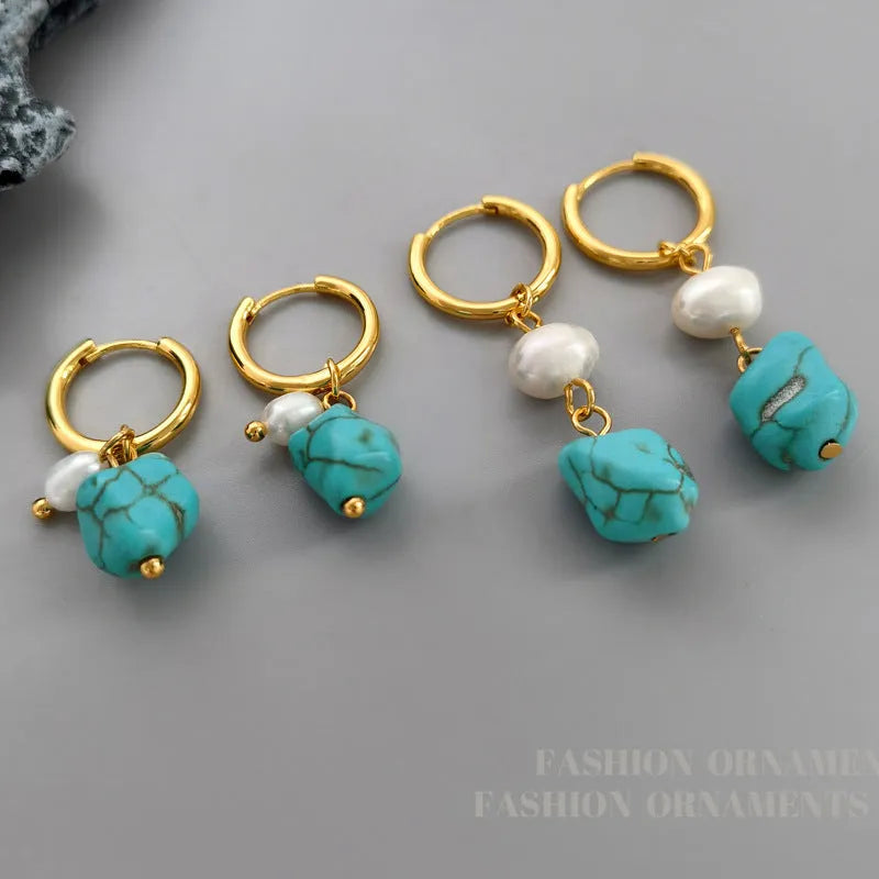 A pair of geometric turquoise and cultured pearl clip-on earrings on a copper setting.