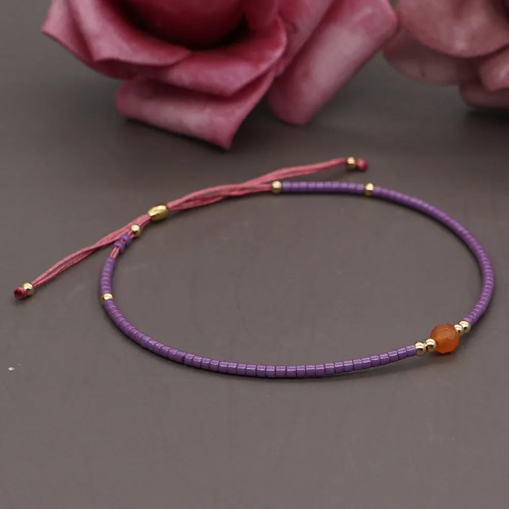 Handmade bohemian style bracelet with colourful geometric glass and coloured glaze beads.