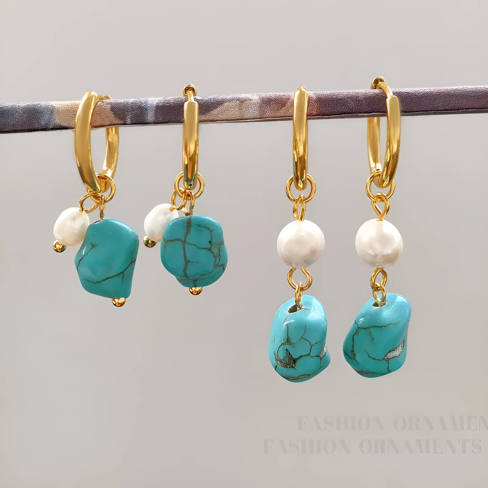 A pair of geometric turquoise and cultured pearl clip-on earrings on a copper setting.