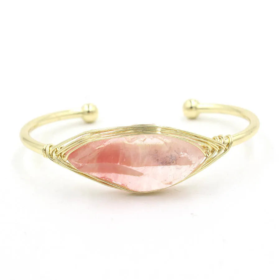 Natural raw gemstone winding bracelet with amethyst, pink crystal, and green fluorite stones on a string with a clasp.