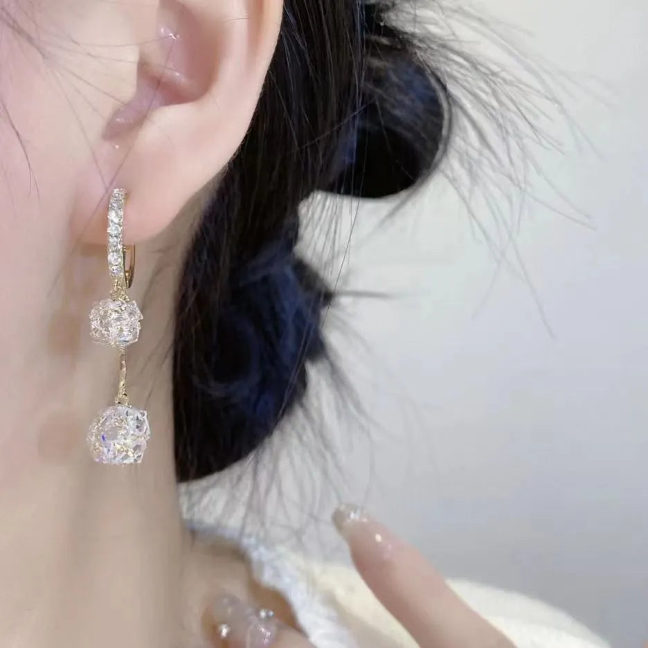 Silver coloured women's earrings with tassel ball and rhinestone ball pendants on ear clips